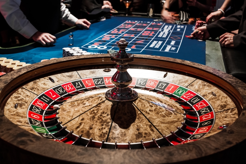 8823097-wooden-shiny-roulette-details-in-a-casino-and-people (1)